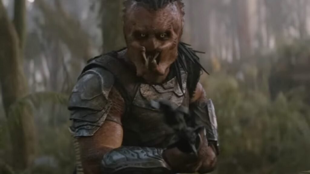 An outcast faces a deadly alien world in Predator: Badlands trailer A Predator on an alien world brandishing a weapon