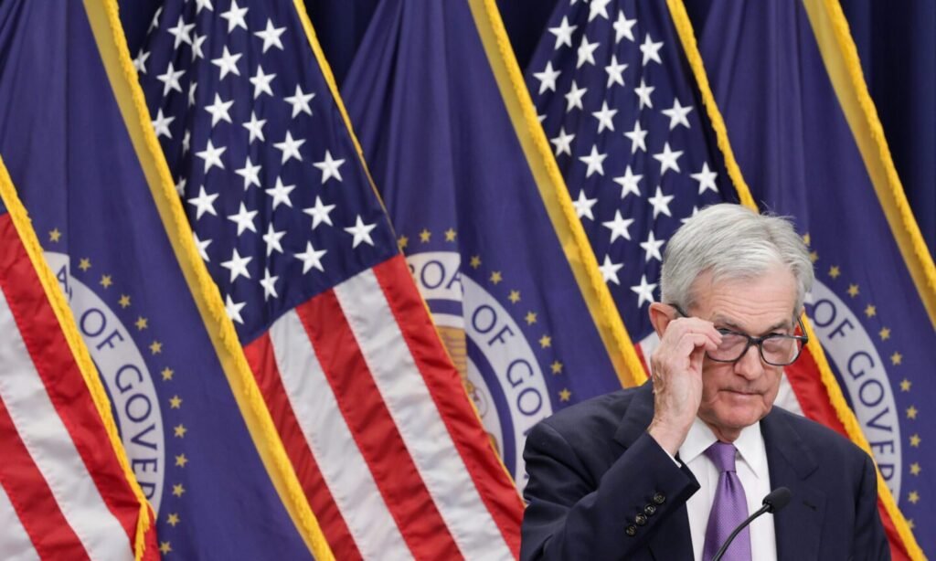 Fed Cuts Rates; Powell Says Future Cuts ‘Far From’ Certain People, Person, Flag