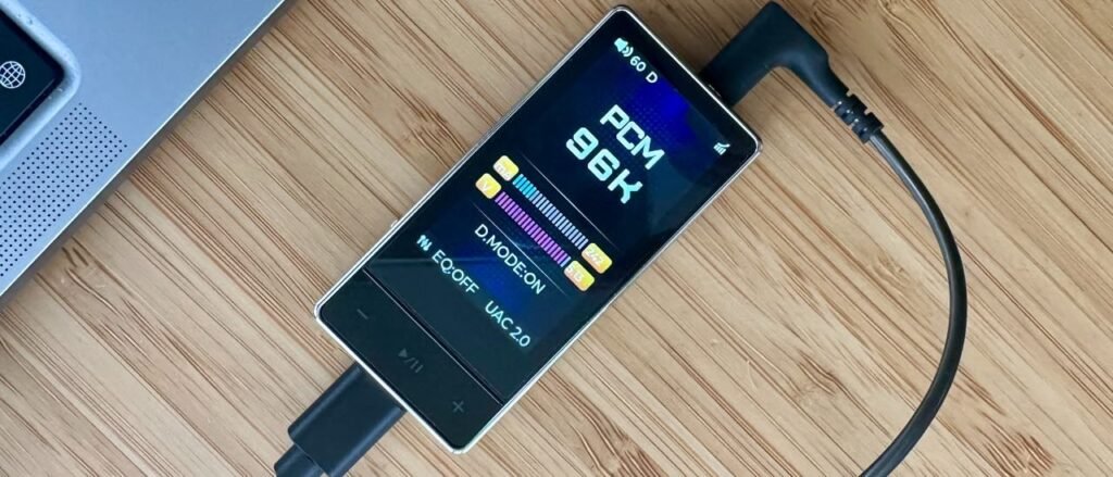 FiiO QX13 review: a headphone amp/DAC to make your smartphone sing, albeit over-eagerly FiiO QX13 headphone amp/DAC on a wooden surface